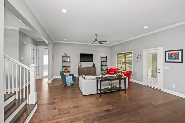 a living room with furniture and kitchen view