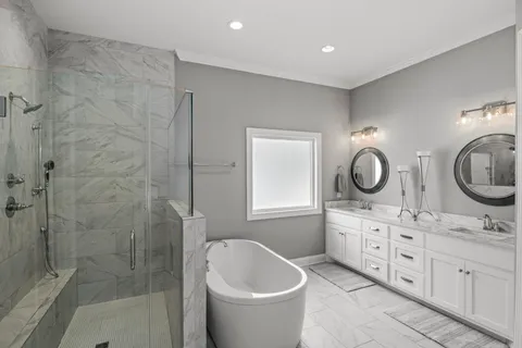 a bathroom with a double vanity sink toilet and shower