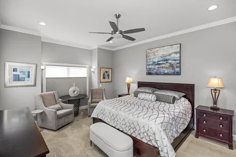 a bedroom with a bed and a chandelier