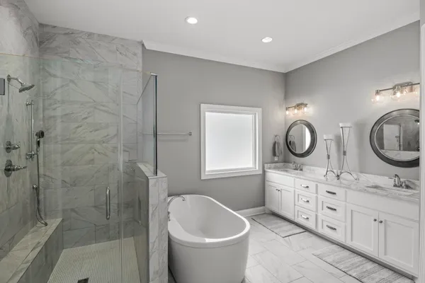 a bathroom with a double vanity sink toilet and shower