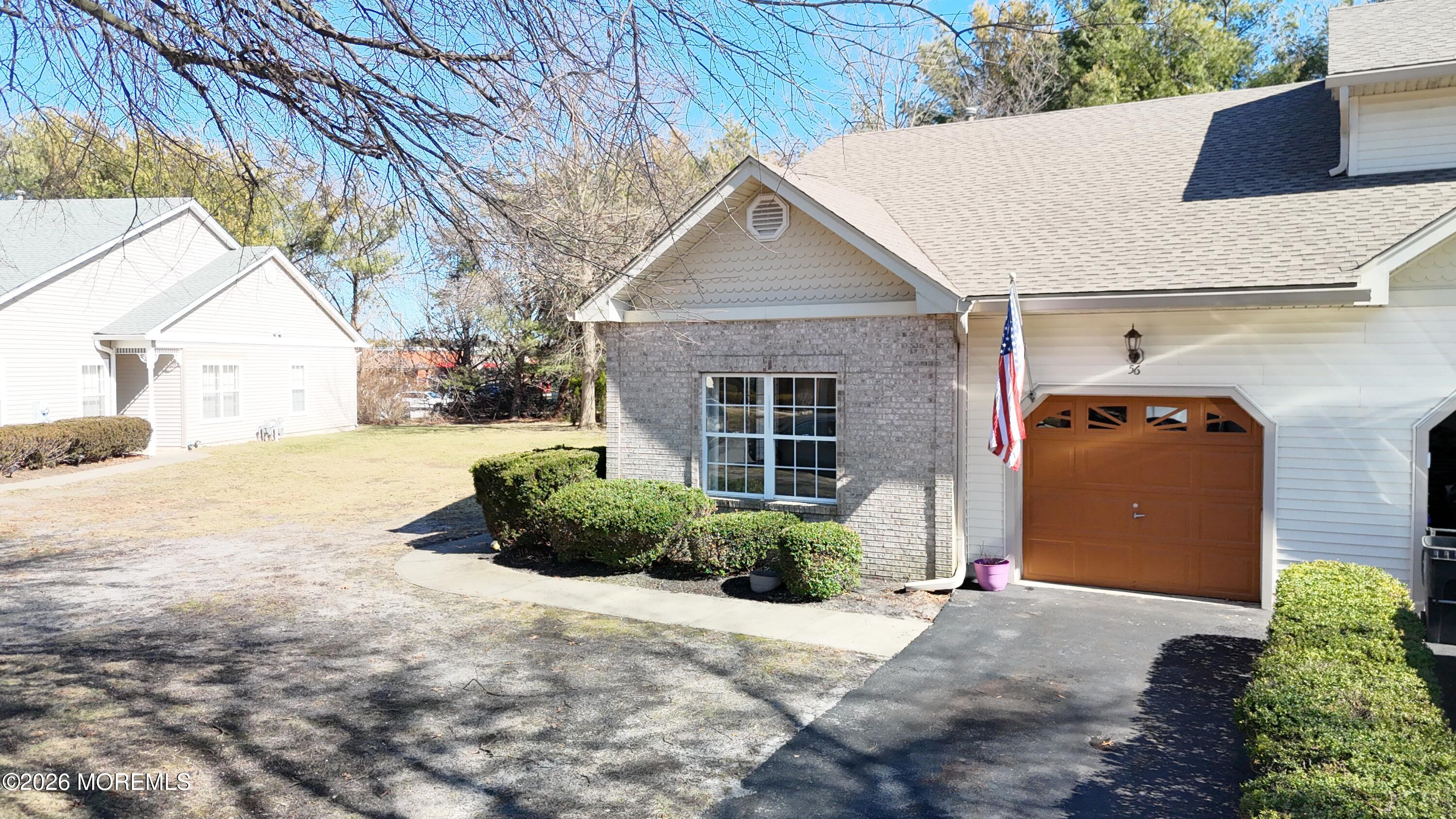 56 Riva Boulevard Brick, NJ 08723 - Photo 14 of 29 a front view of a house with a yard and garage