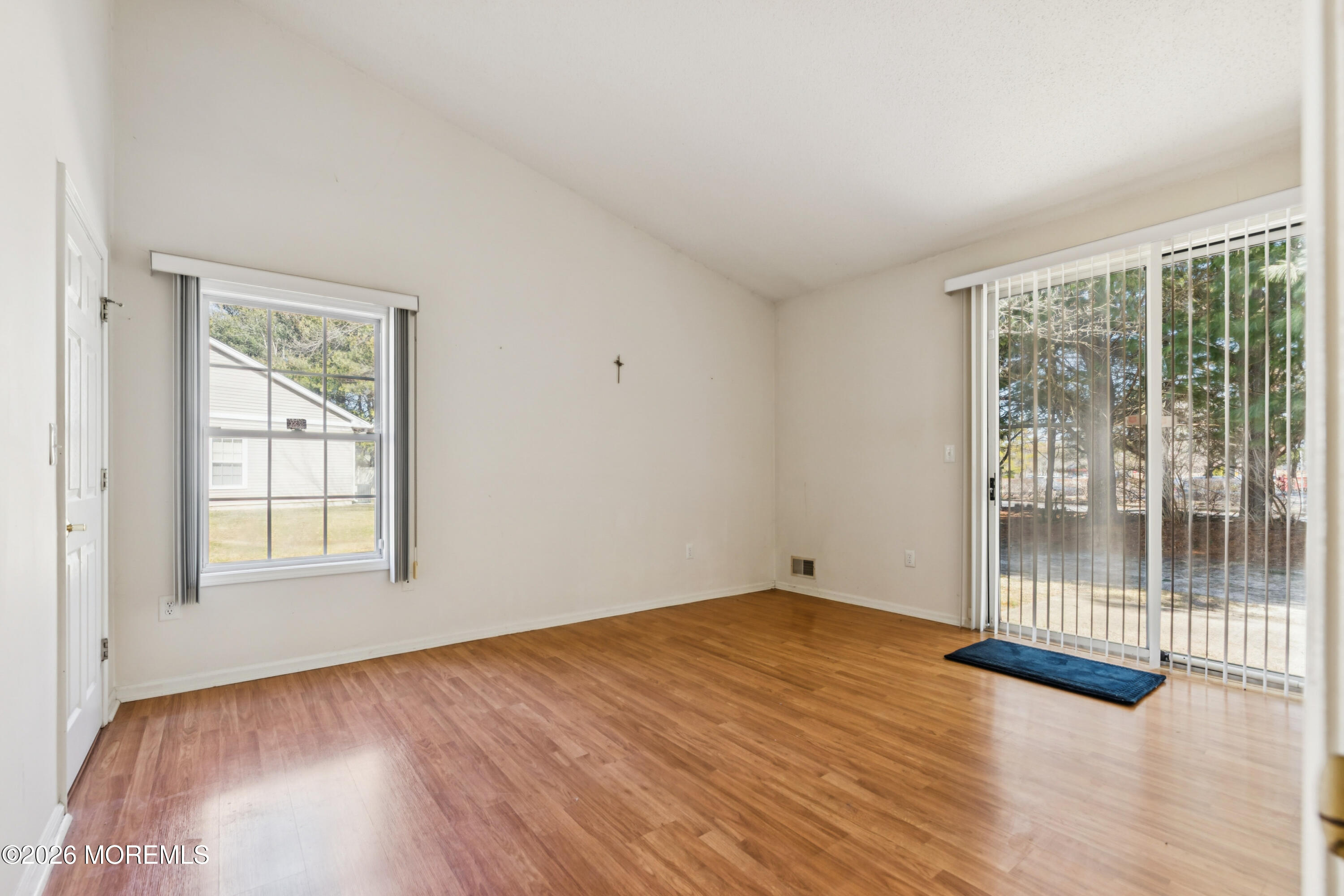 56 Riva Boulevard Brick, NJ 08723 - Photo 20 of 29 an empty room with wooden floor and windows