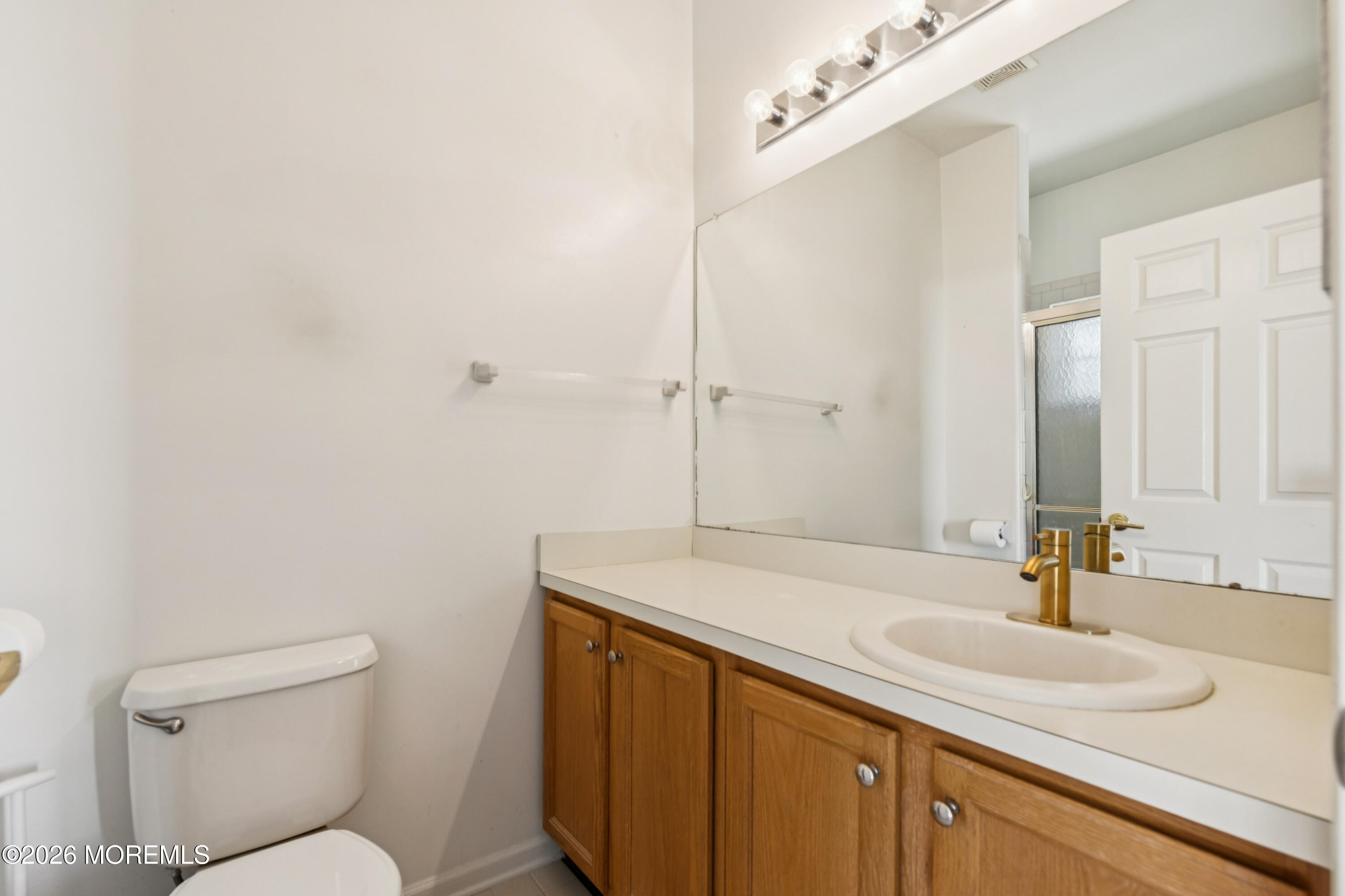 56 Riva Boulevard Brick, NJ 08723 - Photo 22 of 29 a bathroom with a sink and a toilet