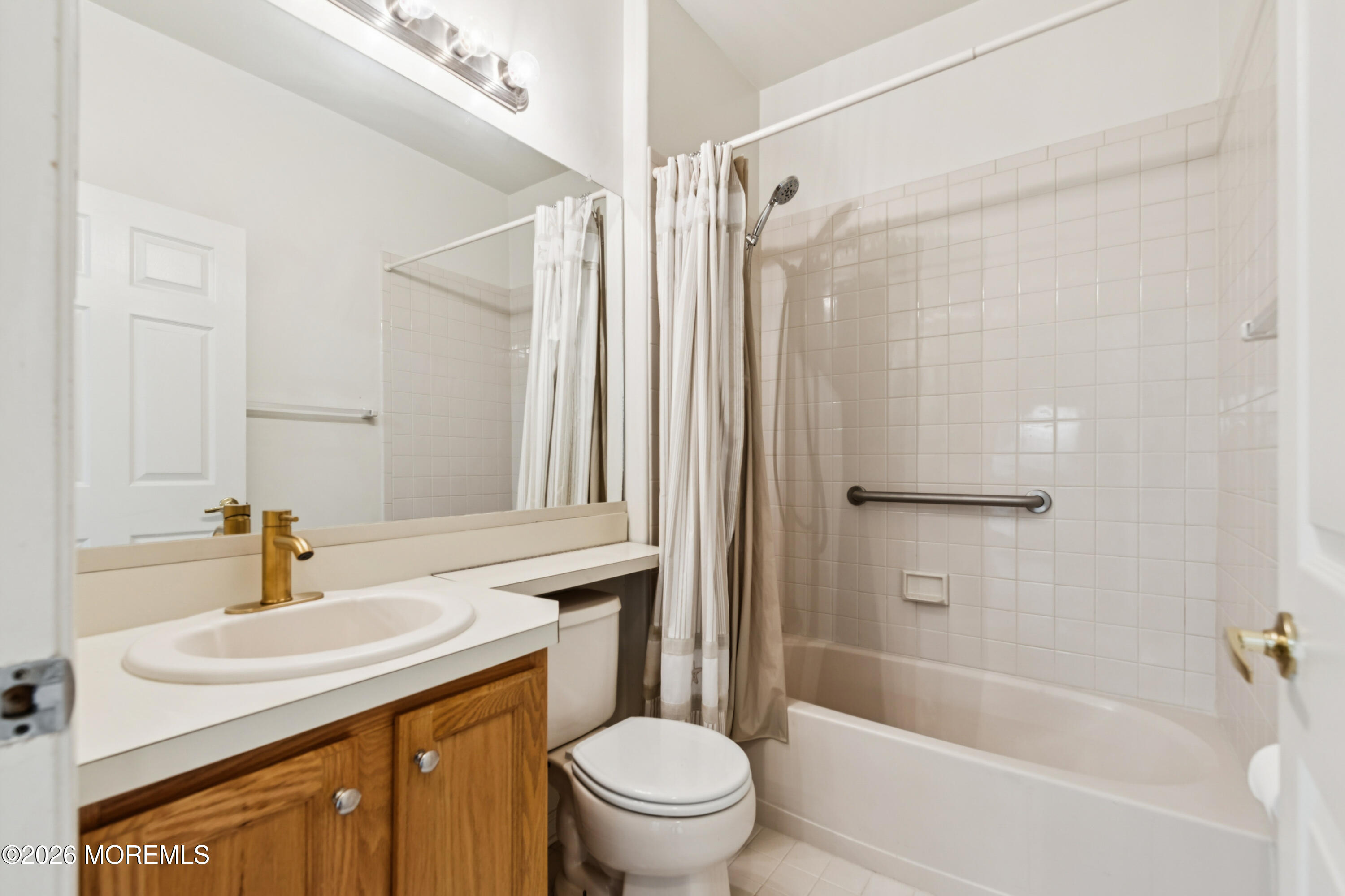 56 Riva Boulevard Brick, NJ 08723 - Photo 28 of 29 a bathroom with a sink a toilet and a bathtub