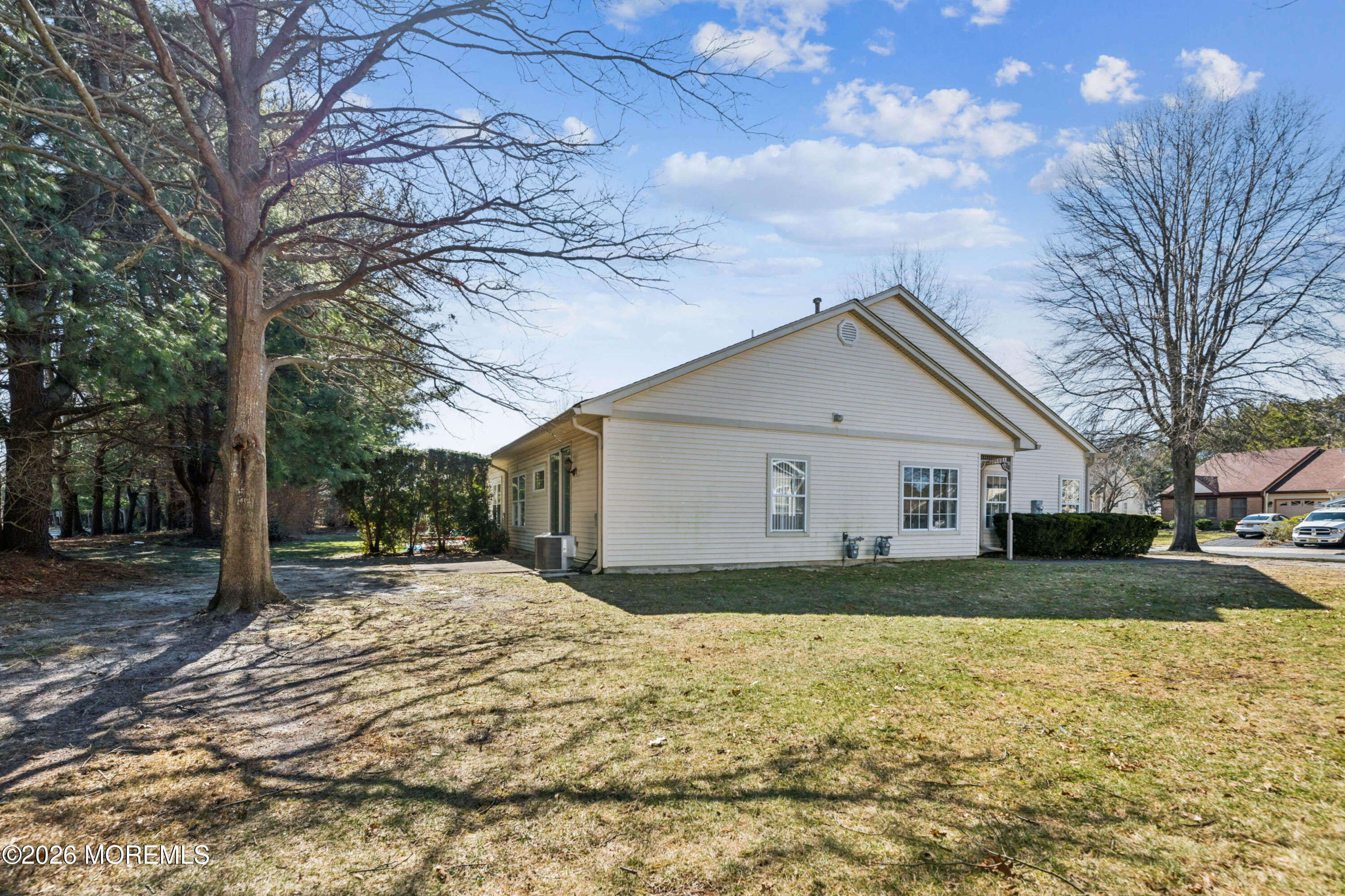 56 Riva Boulevard Brick, NJ 08723 - Photo 3 of 29 a front view of house with yard and trees