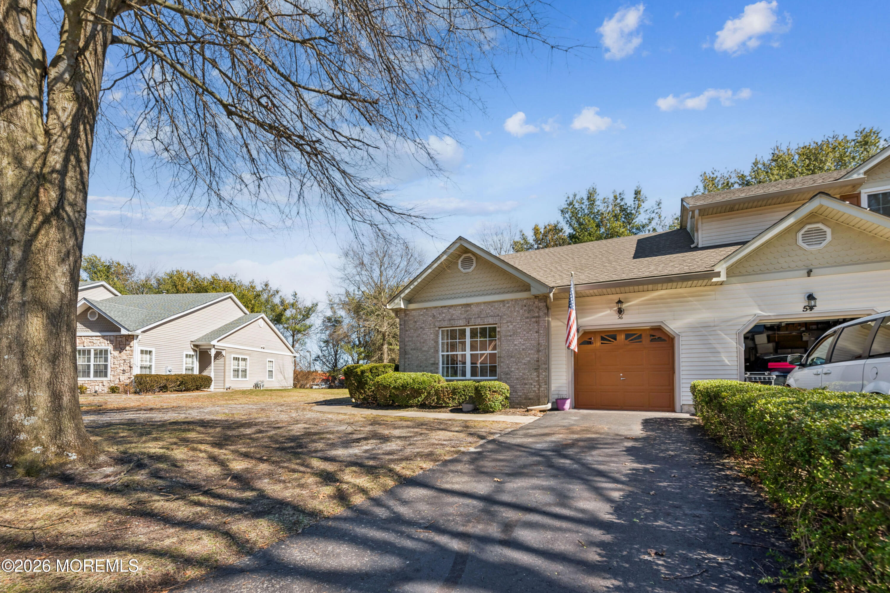 56 Riva Boulevard Brick, NJ 08723 - Photo 6 of 29 a view of a house next to a yard and road