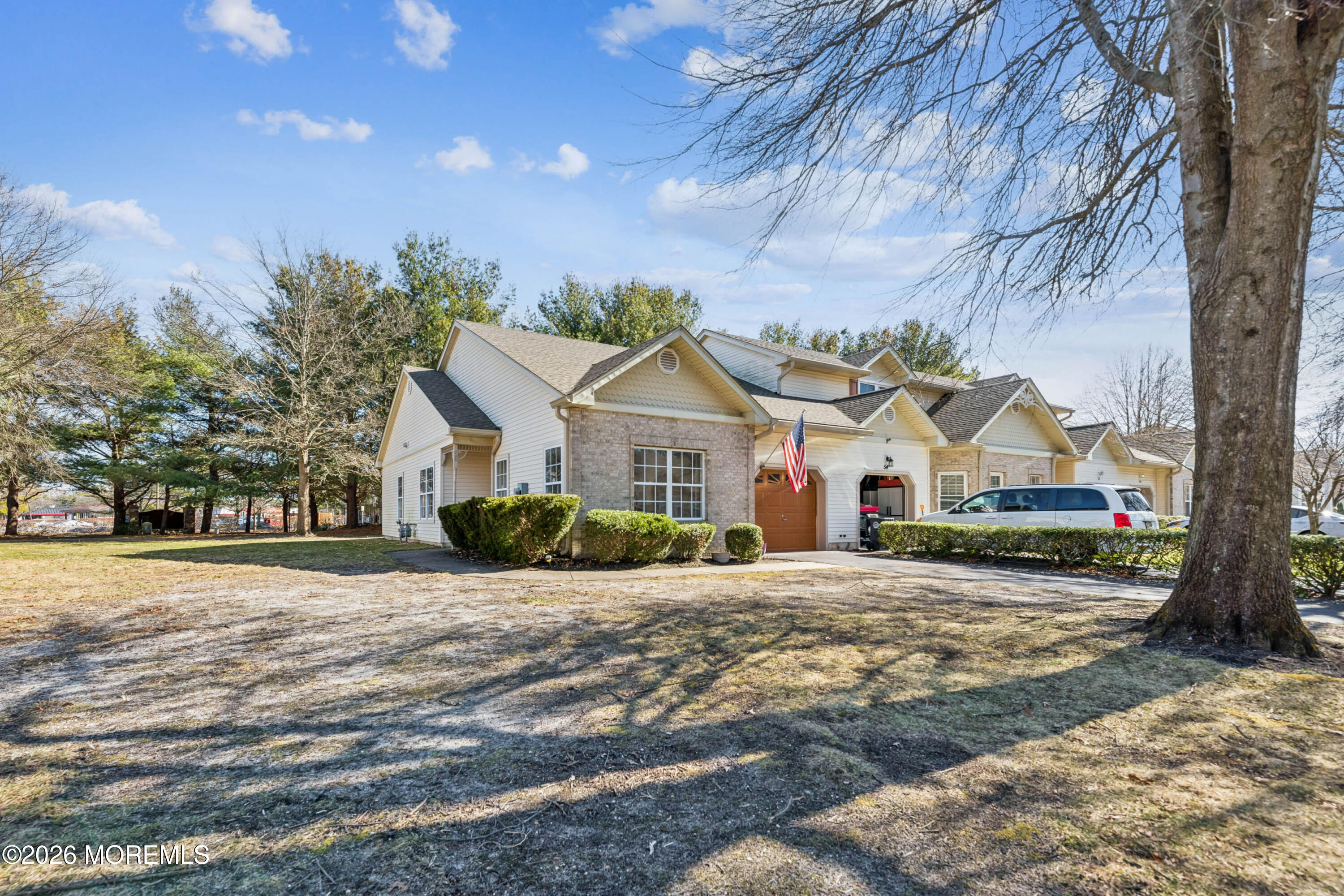 56 Riva Boulevard Brick, NJ 08723 - Photo 7 of 29 a front view of a house with a yard and garage