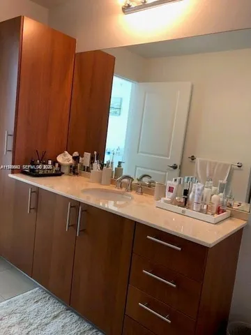 a bathroom with a sink vanity and a mirror