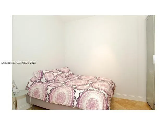 a bedroom with a bed and a wall painting