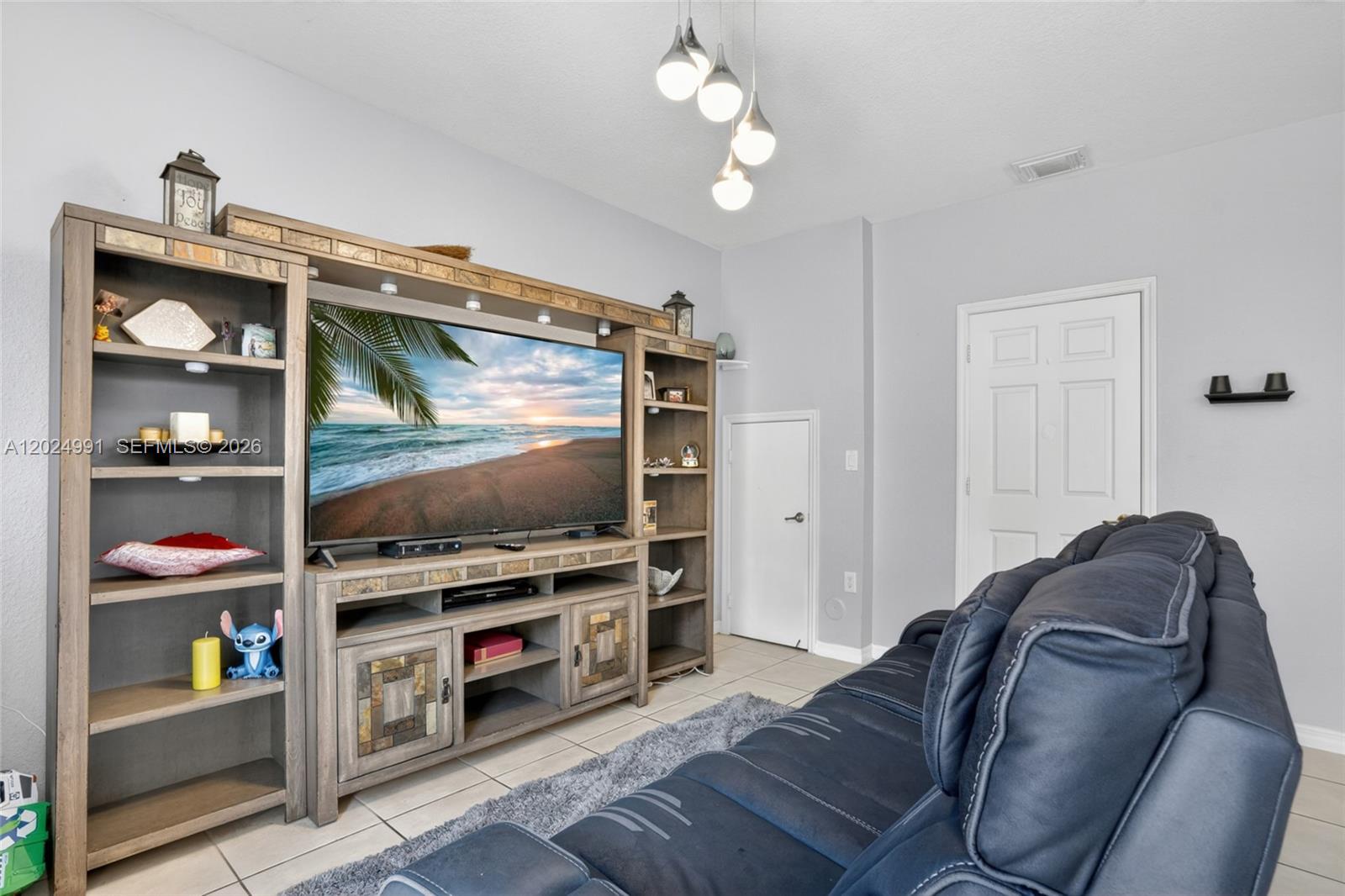 16651 Southwest 79th Terrace Miami, FL 33193 - Photo 19 of 34 a living room with furniture and a flat screen tv