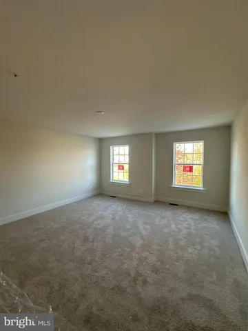 an empty room with windows and entrance