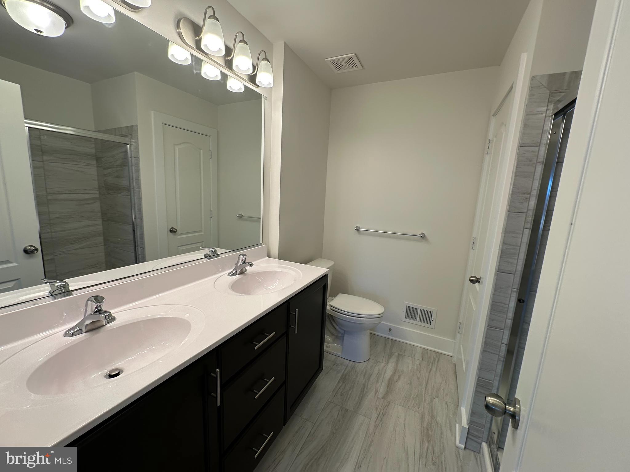 175 Chapel Road Gettysburg, PA 17325 - Photo 16 of 30 a bathroom with a sink a toilet a mirror and shower