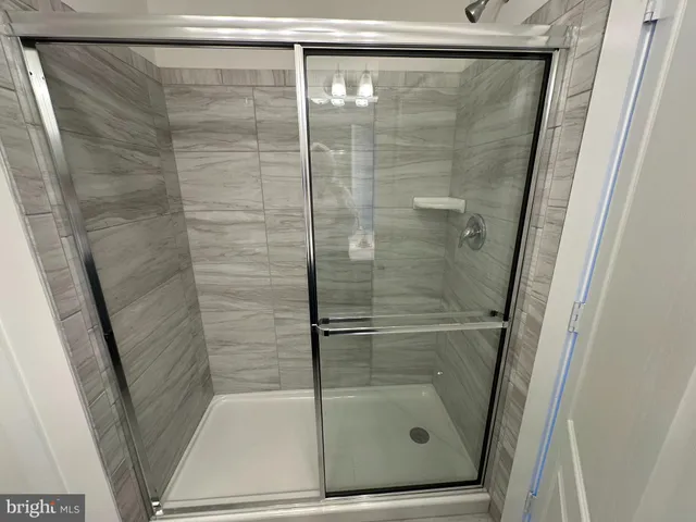 a bathroom with a glass shower door