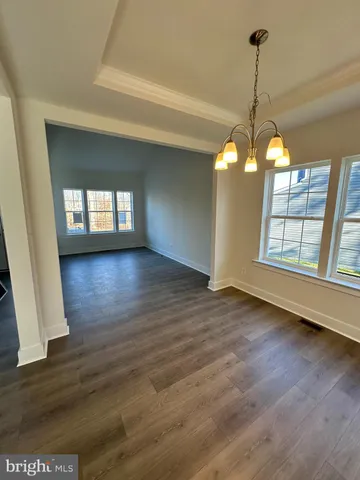 a view of a room with wooden floor and windows