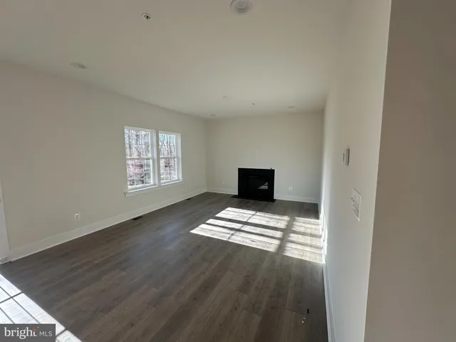 a view of kitchen with wooden floor and electronic appliances
