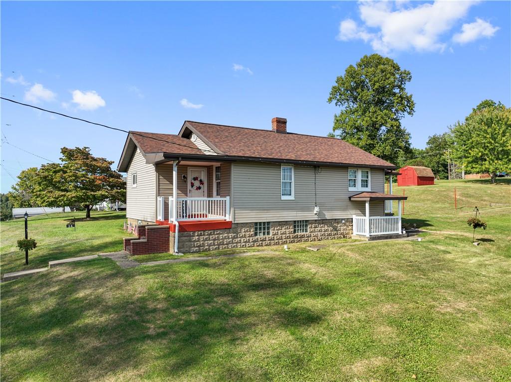 a view of a house with a yard porch and sitting area