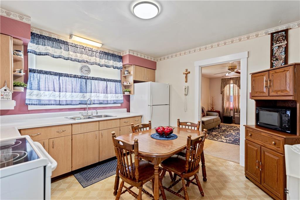 14 Pumpkin Center Road Finleyville, PA 15332 - Photo 5 of 34 a kitchen with a dining table chairs and white cabinets