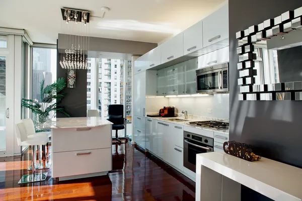 a kitchen with a table chairs refrigerator and microwave