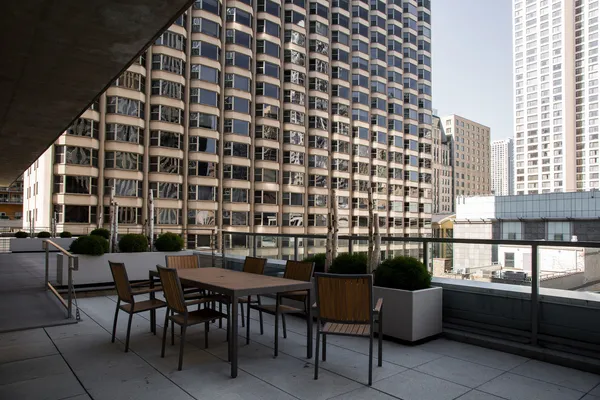a view of a patio with a table and chairs and potted plants