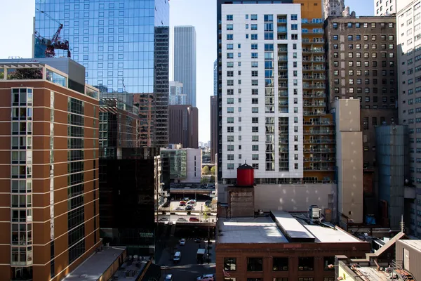 a view of balcony with a couple of cars parked on road