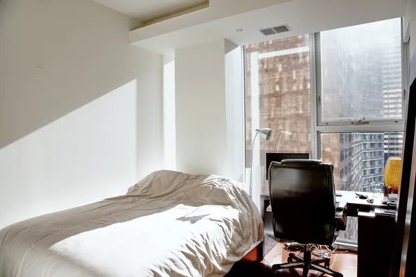 a bedroom with a bed and a window