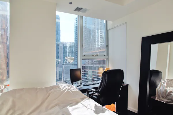a bedroom with a bed and a desk