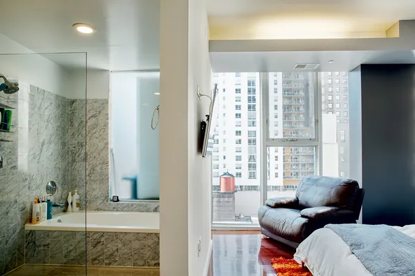 a living room with furniture and a floor to ceiling window