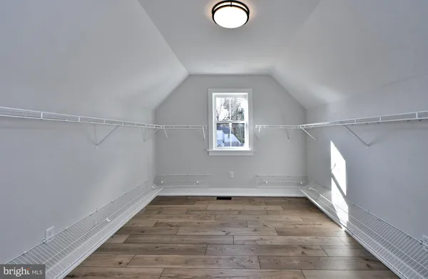 a view of a room with wooden floor and window