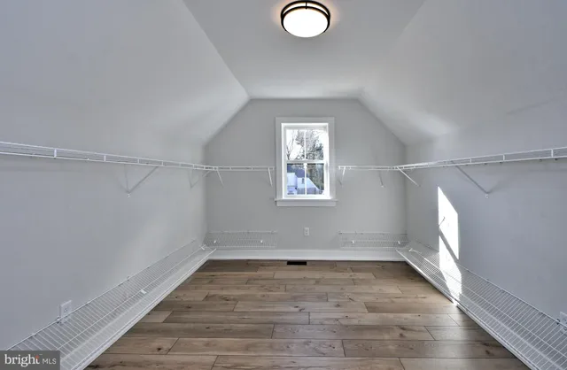 a view of a room with wooden floor and window
