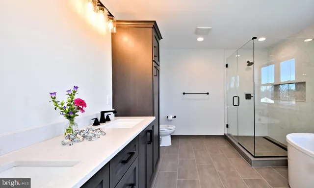 a bathroom with a sink mirror and a shower