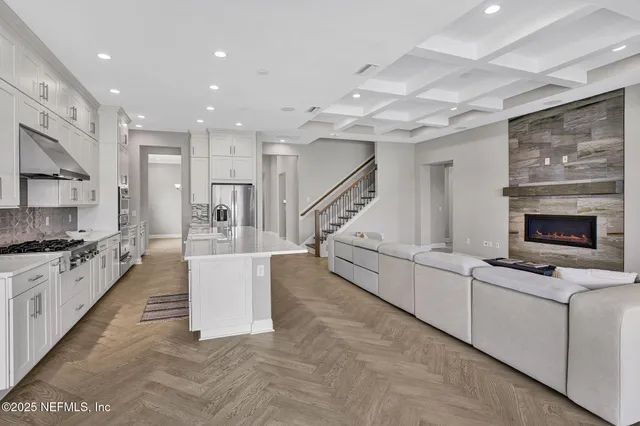 a large white kitchen with a stove a sink and a refrigerator