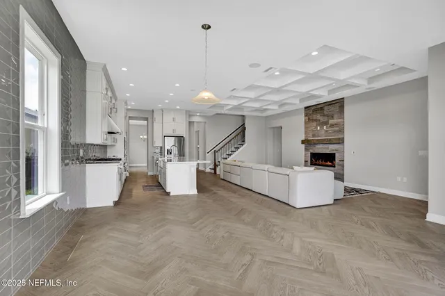 a view of kitchen with furniture and refrigerator