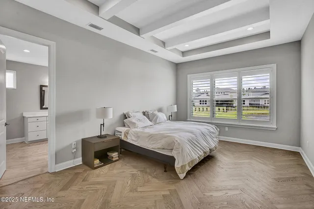 a spacious bedroom with a large bed and a window