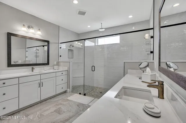 a bathroom with a double vanity sink and mirror
