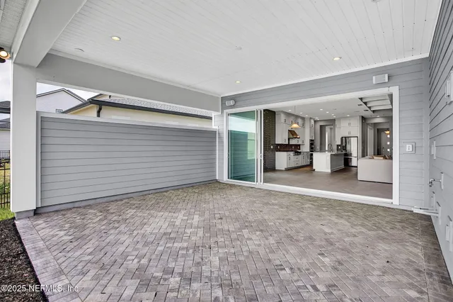 a view of a big room with closet and wooden shelves