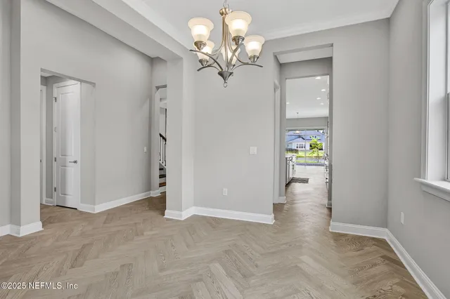 a view of a chandelier in big room and hallway