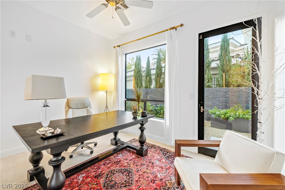 2000 Grouse Street Las Vegas, NV 89134 - Photo 30 of 89 An inviting home office boasts a ceiling fan, a large window, and direct access to the courtyard, blending comfort with convenience.