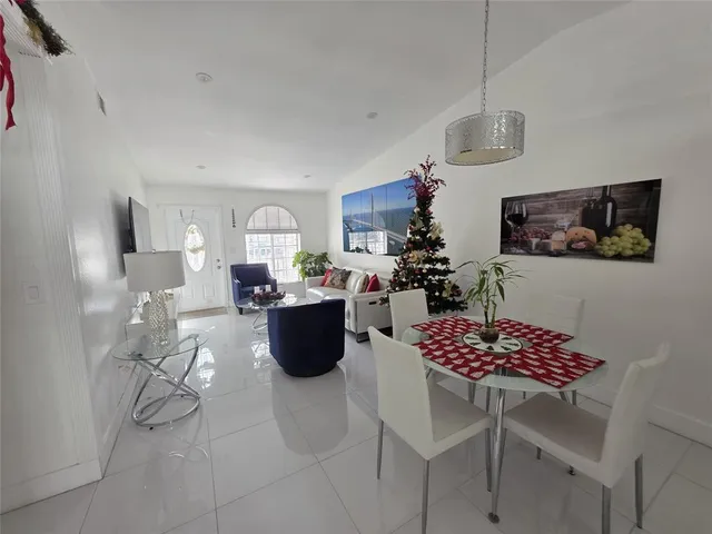 a view of kitchen with stainless steel appliances granite countertop a dining table and chairs