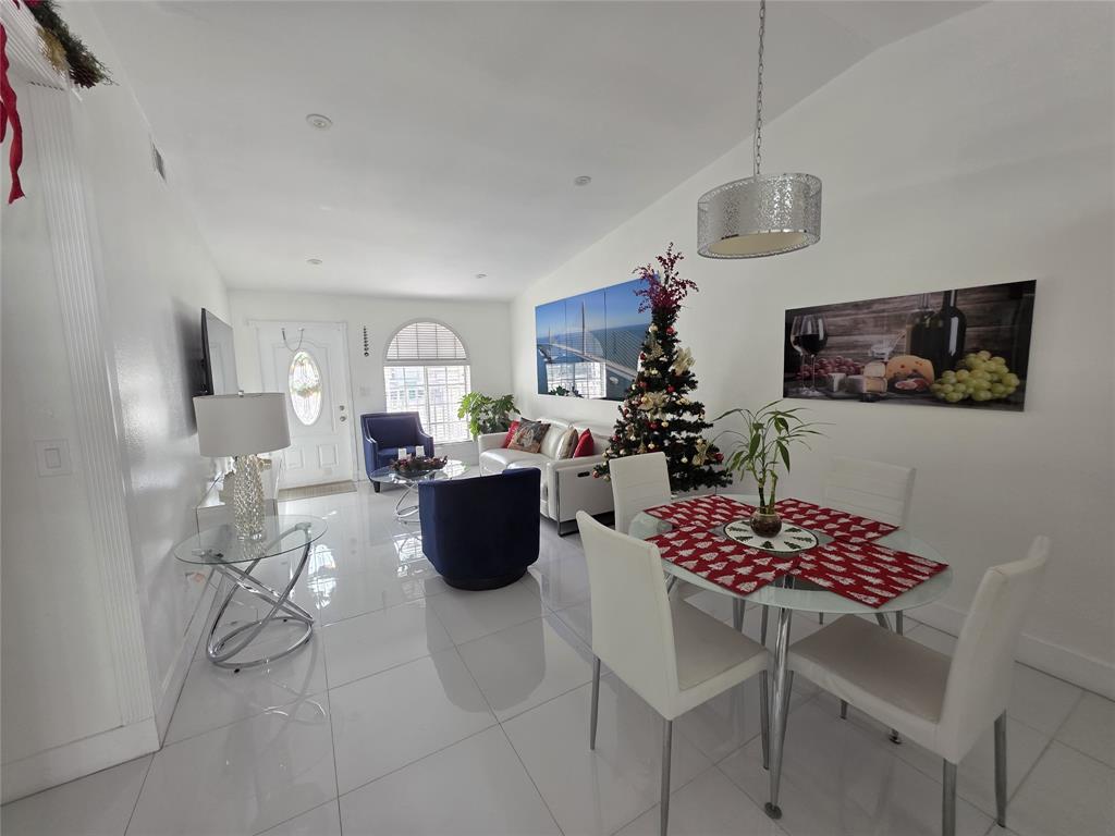 7635 Northwest 181st Street Hialeah, FL 33015 - Photo 3 of 12 a view of kitchen with stainless steel appliances granite countertop a dining table and chairs