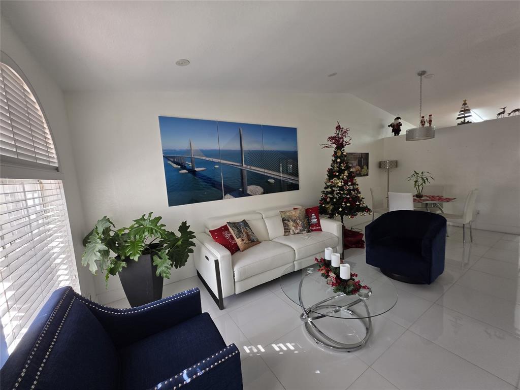 7635 Northwest 181st Street Hialeah, FL 33015 - Photo 4 of 12 a living room with furniture flowers and a potted plant