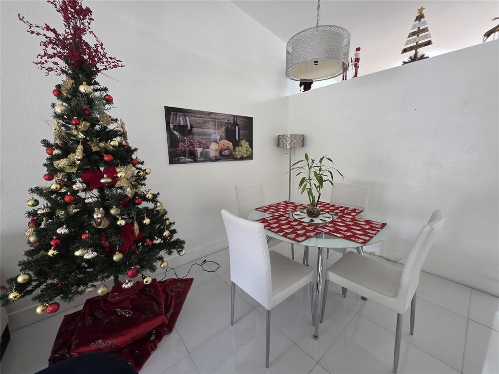 7635 Northwest 181st Street Hialeah, FL 33015 - Photo 6 of 12 a view of a dining room with furniture and a chandelier