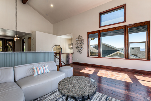 5326 North Oldgate Road Heber City, UT 84032 - Photo 6 of 32 Spacious living area featuring high vaulted ceilings, rich wood-finish flooring, and multiple large windows with dark wood trim