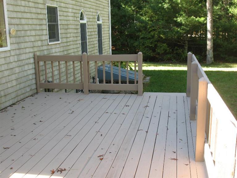 6 Yearling Run Road Buzzards Bay, MA 02532 - Photo 31 of 34 a view of house with deck outdoor seating and covered with trees in the background