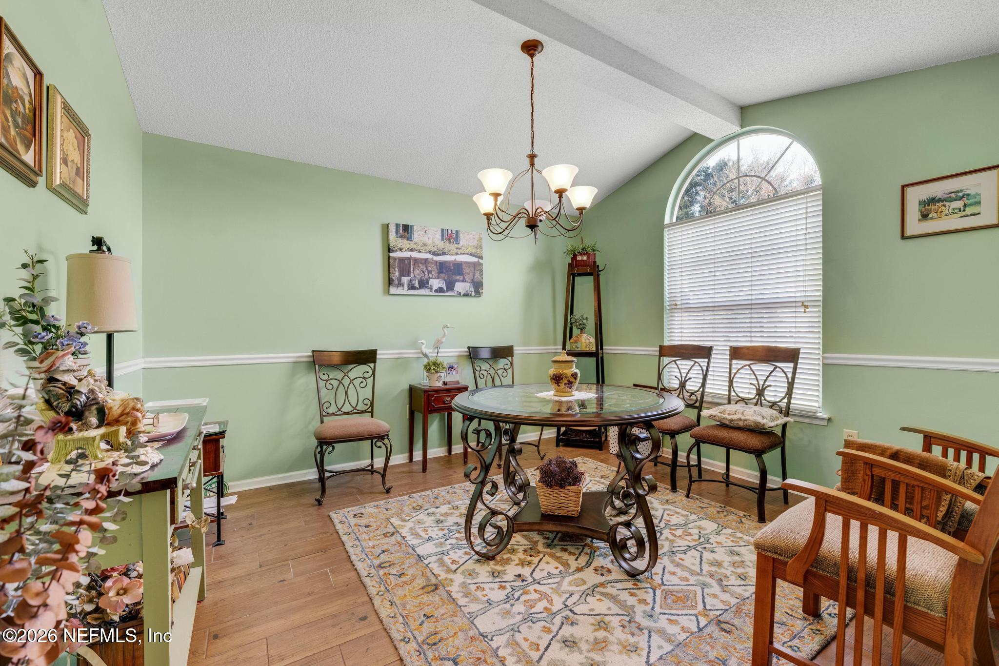 3566 Pond Ridge Court West Jacksonville, FL 32223 - Photo 4 of 13 a view of a dining room with furniture a rug and wooden floor