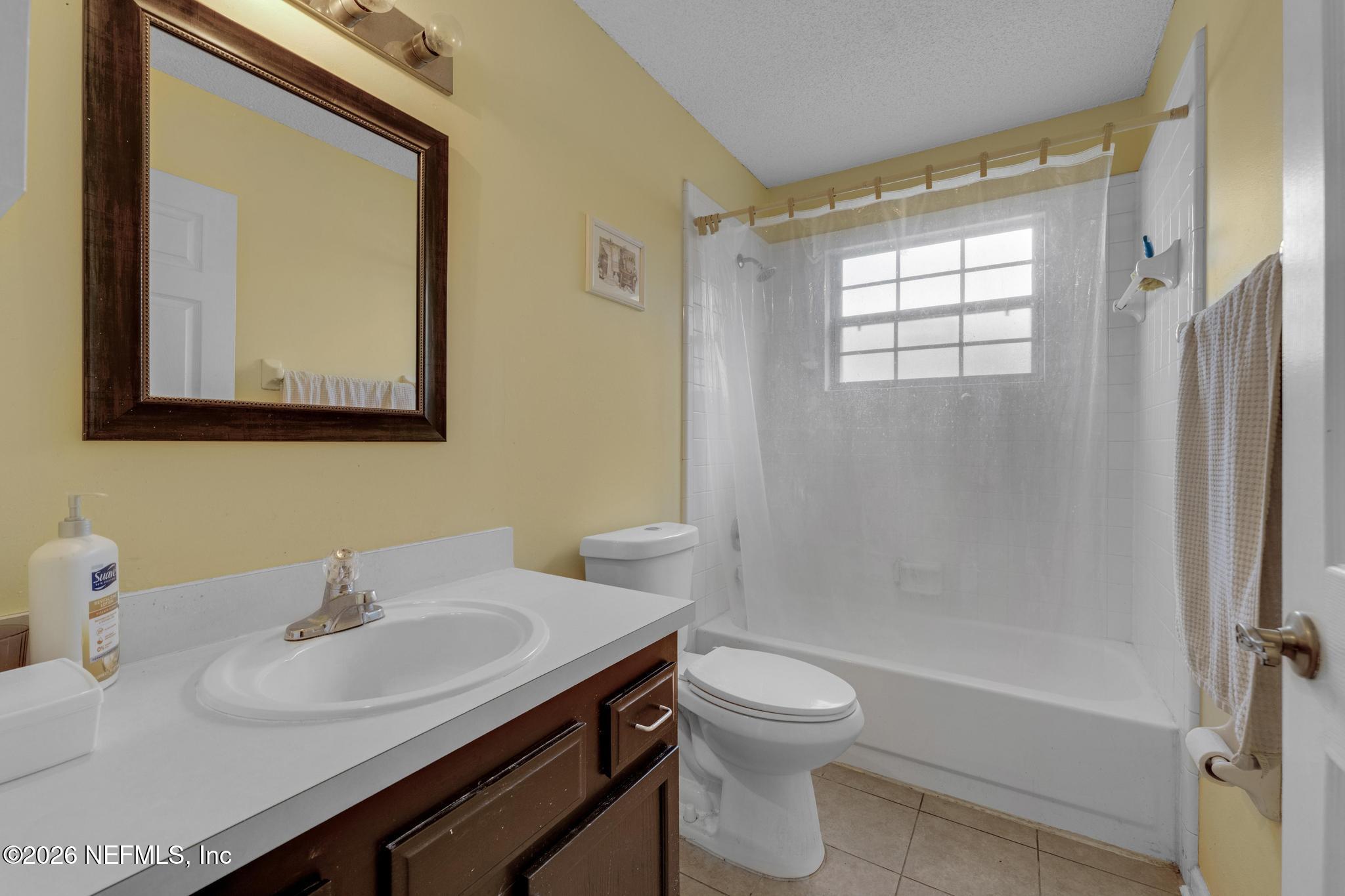 3566 Pond Ridge Court West Jacksonville, FL 32223 - Photo 8 of 13 a bathroom with a sink toilet and shower
