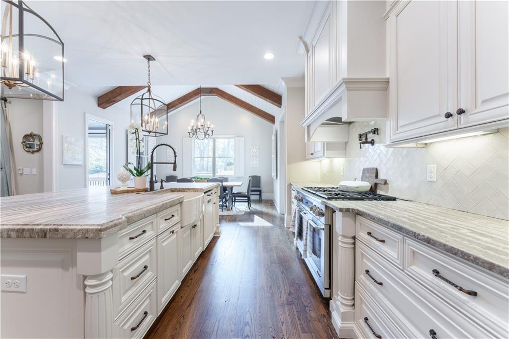 999 Ferncliff Road Northeast Atlanta, GA 30324 - Photo 14 of 52 a kitchen with stainless steel appliances granite countertop a lot of counter space and wooden floors