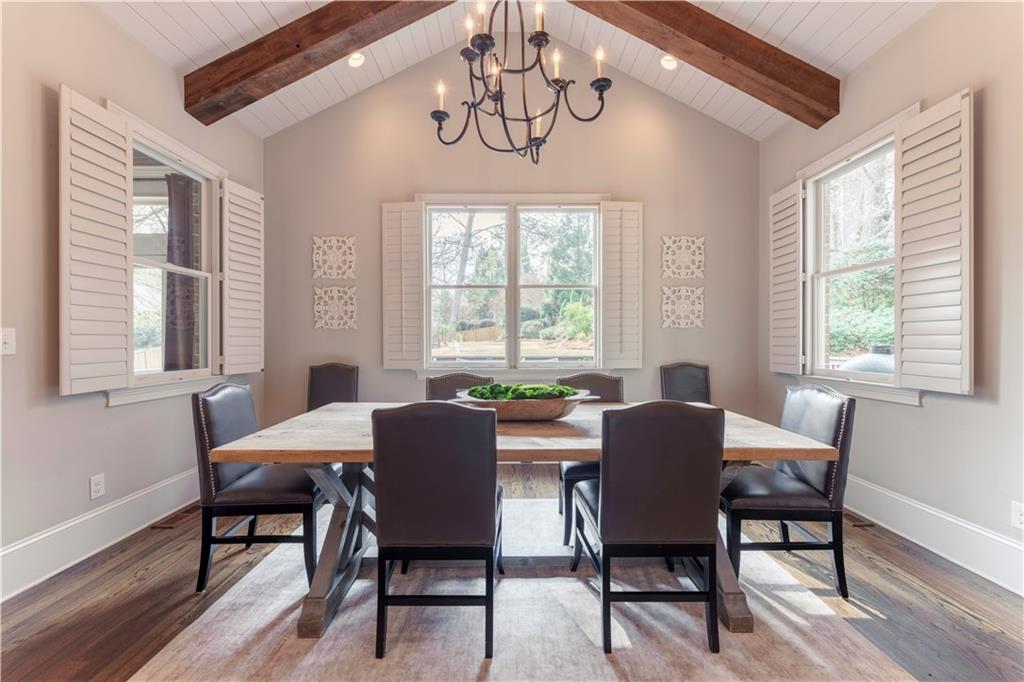 999 Ferncliff Road Northeast Atlanta, GA 30324 - Photo 18 of 52 a dining room with furniture a chandelier and wooden floor