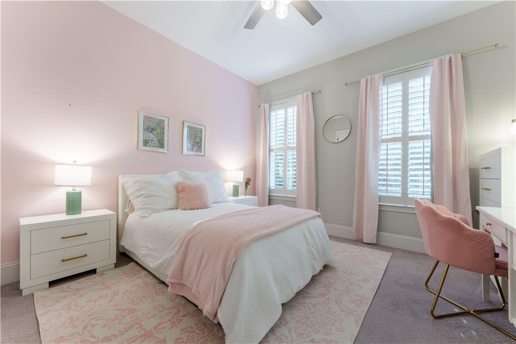 999 Ferncliff Road Northeast Atlanta, GA 30324 - Photo 28 of 52 a bedroom with a bed and a chair