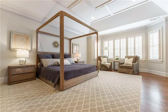 a bedroom with furniture and a large window