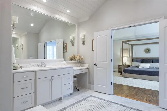 a spacious bathroom with a granite countertop sink mirror and shower